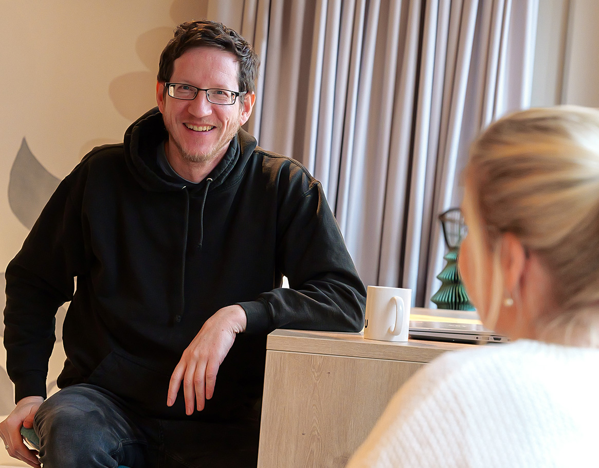 Zwei Männer arbeiten fröhlich zusammen und haben eine Mindmap auf einem Whiteboard abgebildet